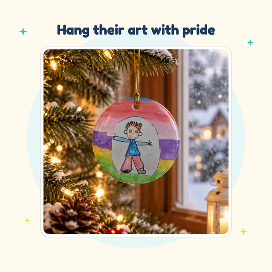 Custom ceramic Christmas ornament printed with a child's drawing, hanging on a tree by a snowy window